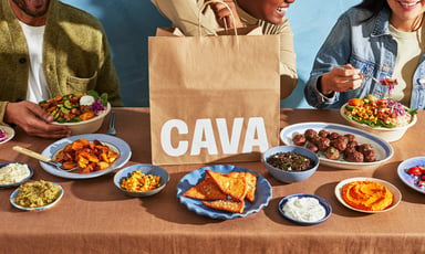 people eating on a table wit CAVA logo in view_CAVA