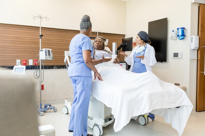 Healthcare providers conferring with a patient.
