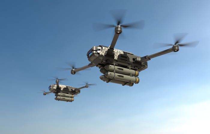 A pair of military drones in the sky.