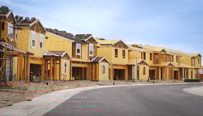 A street lined with homes under construction.