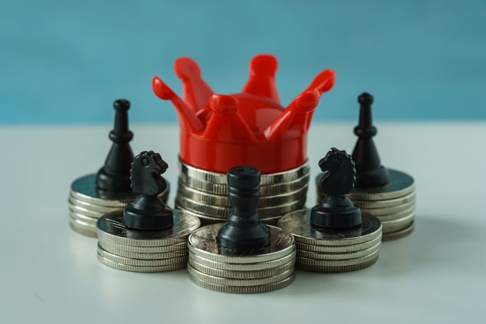A crown on a stack of coins.