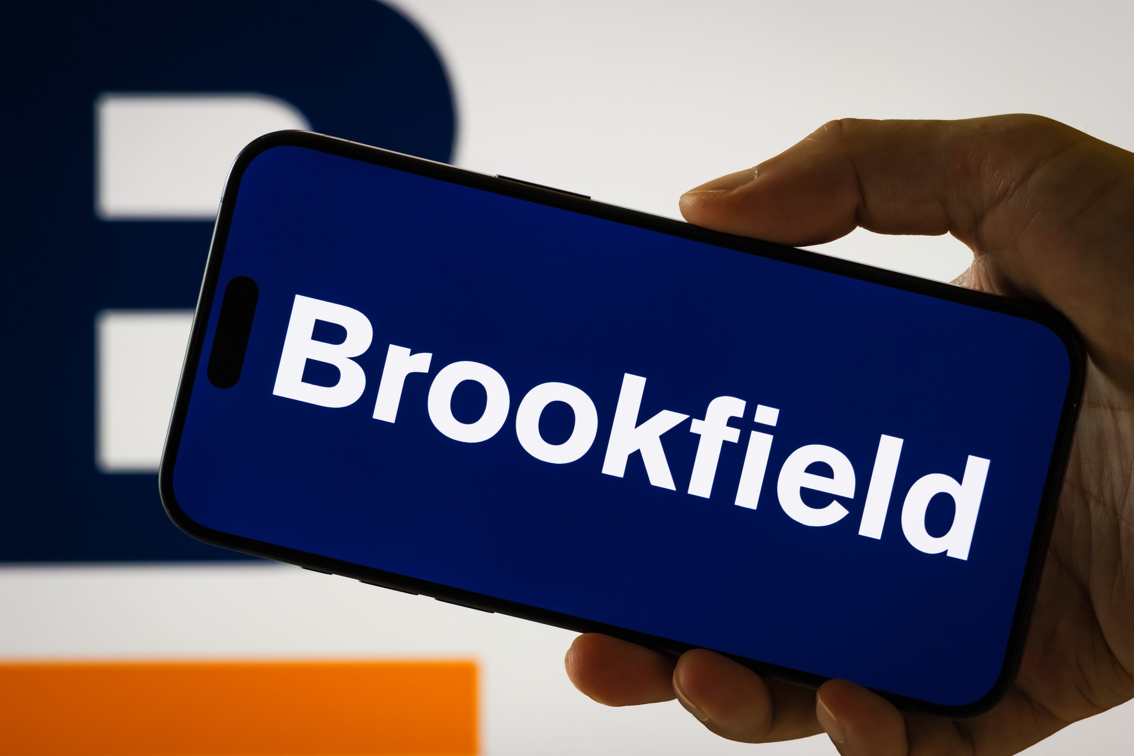 brookfield logo wordmark on smartphone with blurry brookfield logo background-BN