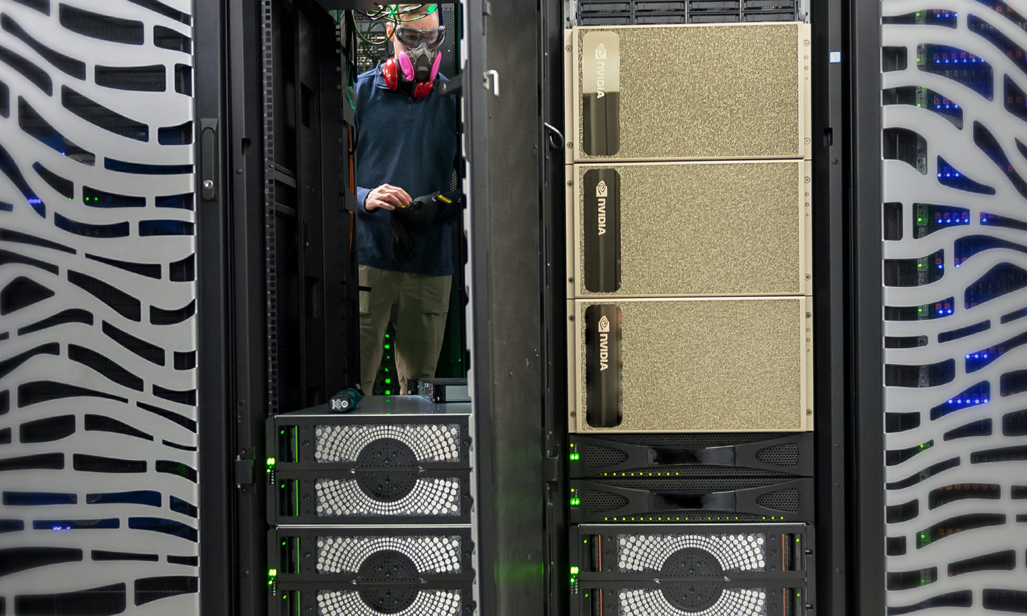 Worker at a server with Nvidia hardware inside a data center.