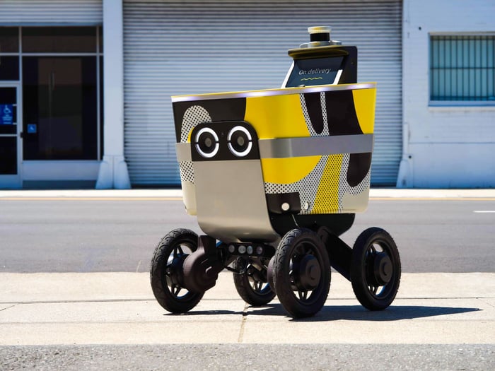 A Seve Robotics yellow and black sidewalk robot.