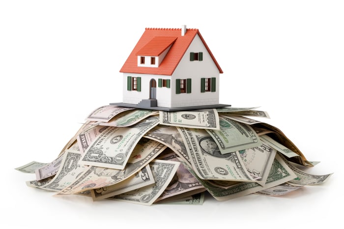 A house on top of a pile of cash.