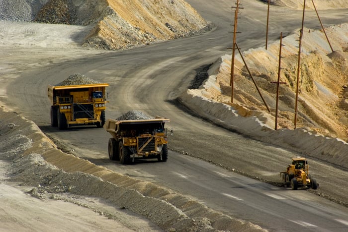 Large dump trucks on a mining path.