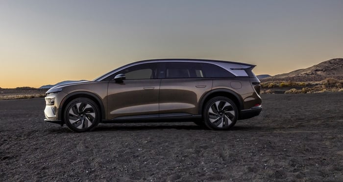 A Lucid Gravity, an electric SUV, in a desert setting. 