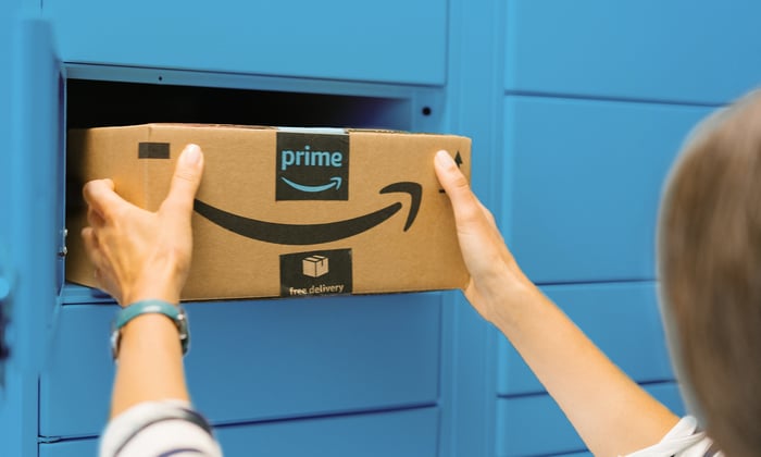 A person takes an Amazon package out of a Prime locker.