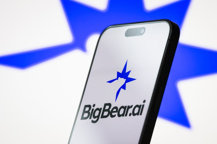bigbear ai logo on smartphone with blurry blue star logo background.
