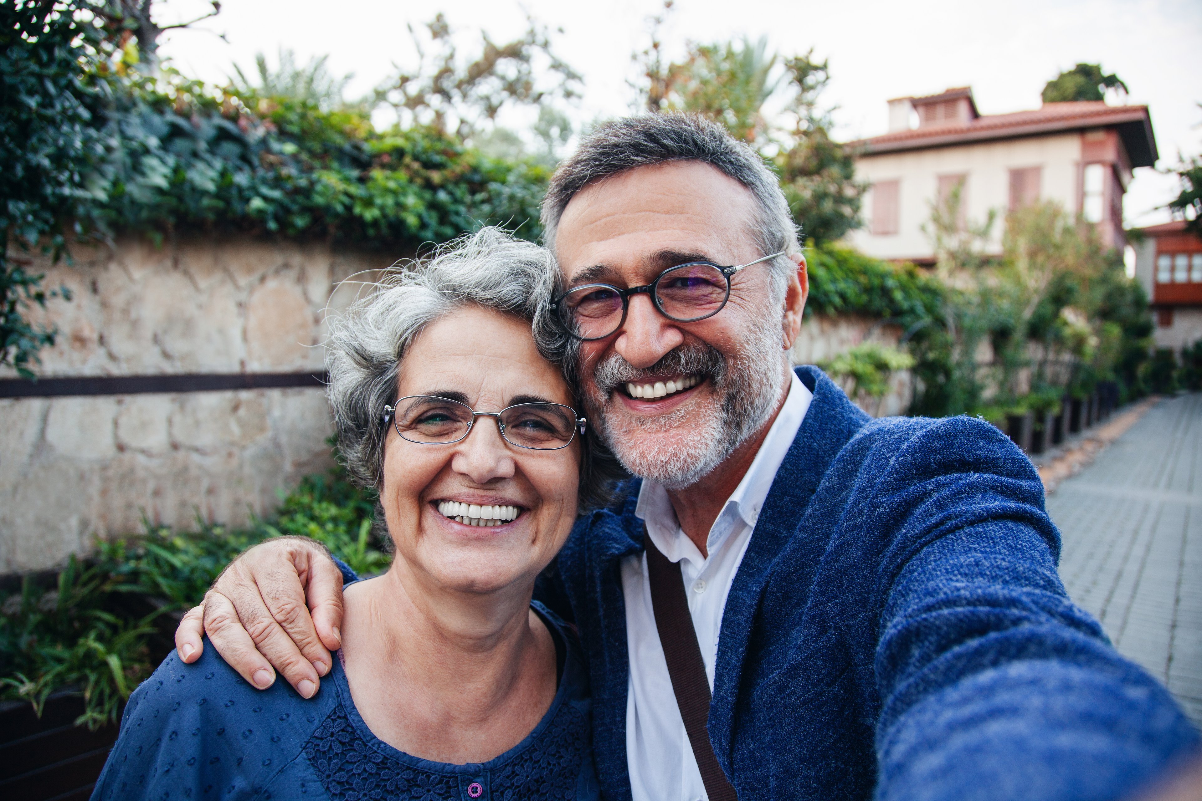 Getty - couple in blue outdoors smiling selfie