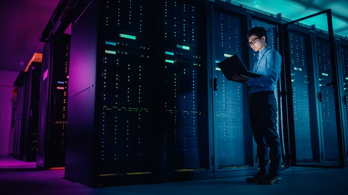 Image of an engineer standing in a data center.
