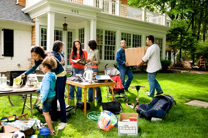 People gathering at a neighborhood yard sale.