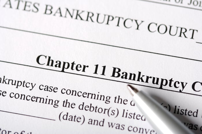 A pen pointing the the words Chapter 11 Bankruptcy