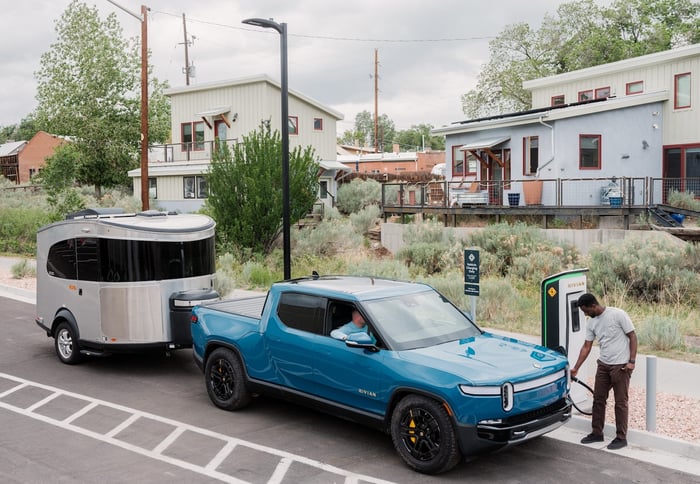 A blue truck on a street.