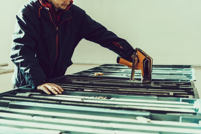 Worker using a power tool.