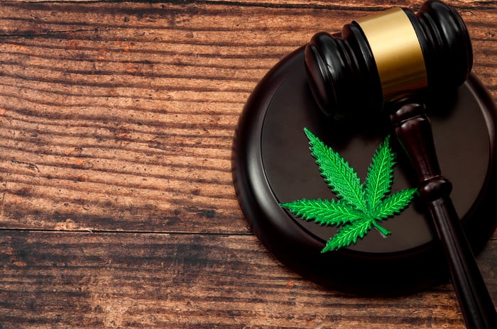 A marijuana leaf next to a gavel.
