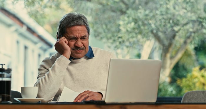 Someone looking skeptically at a laptop.
