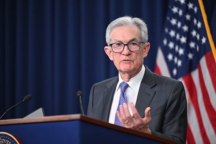 Federal Reserve Chairman Jerome Powell answering questions behind a podium.