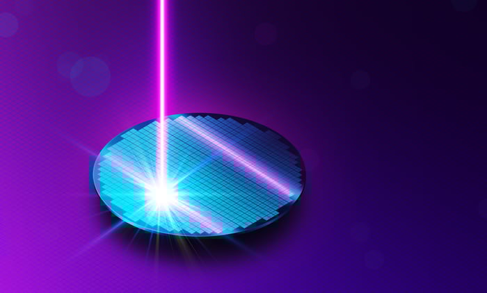 Laser light shining onto a circular wafer. 