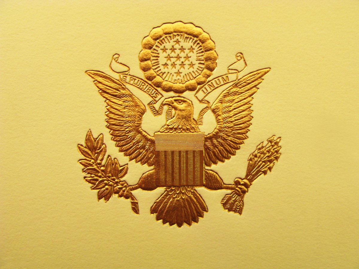 U.S. Presidential seal in gold.
