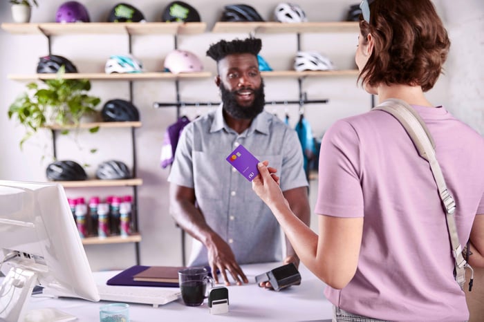 A person using a Nu credit card.