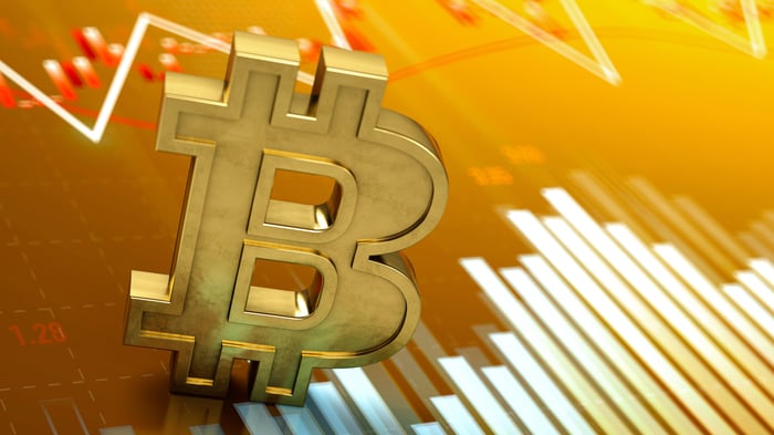 Bitcoin logo atop a stock chart.