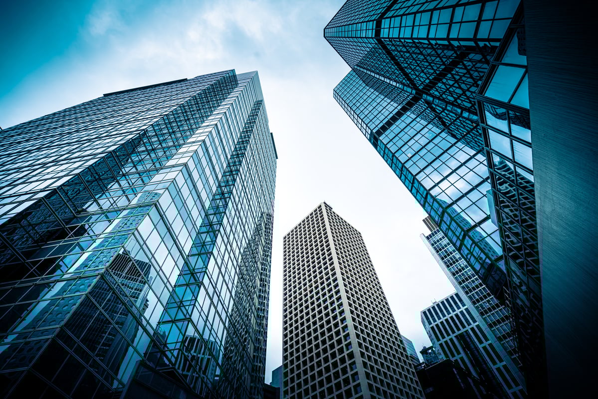 Glass skyscrapers viewed from sidewalk level.