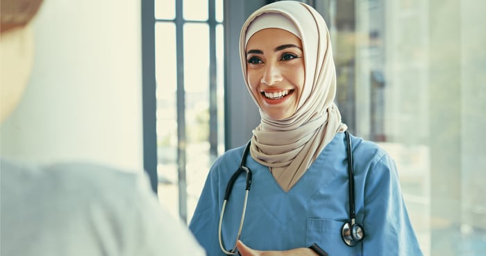 Someone with a stethoscope around their shoulders.