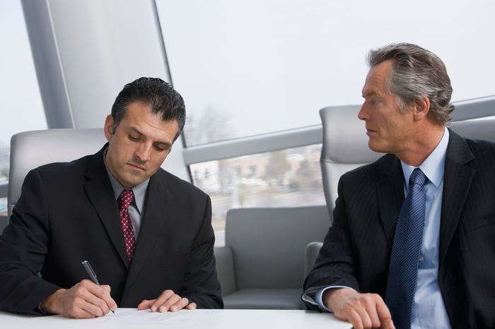 Two people sitting at table.