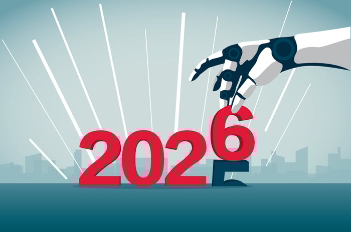 A robotic hand replaces the "5" in "2025" by a "6."