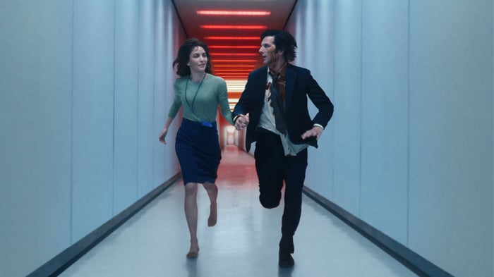 Actors from Apple's TV show, severance, running down a hall.