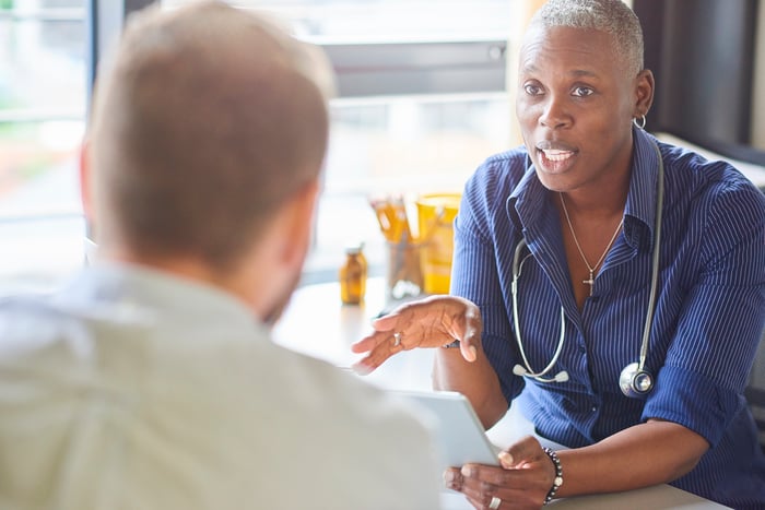 Patient talking with doctor.