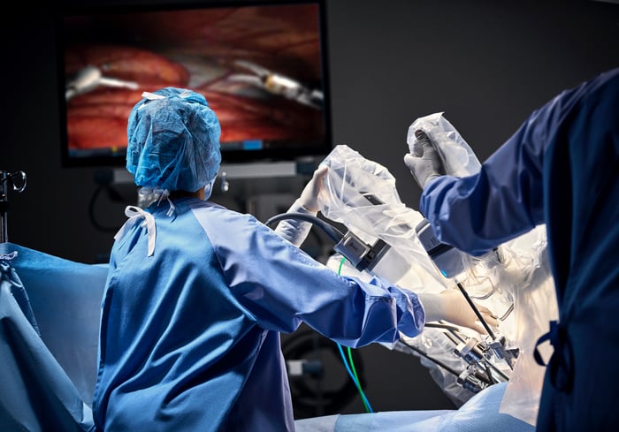 A medical professional using an Intuitive Surgical da Vinci system.