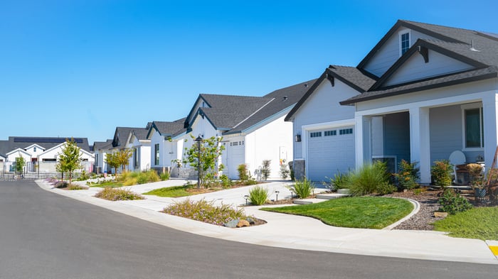 A row of houses on a quiet residential street on a clear sunny day.