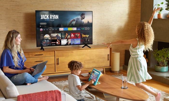 Amazon Fire TV with Prime Video on screen in living room with family.