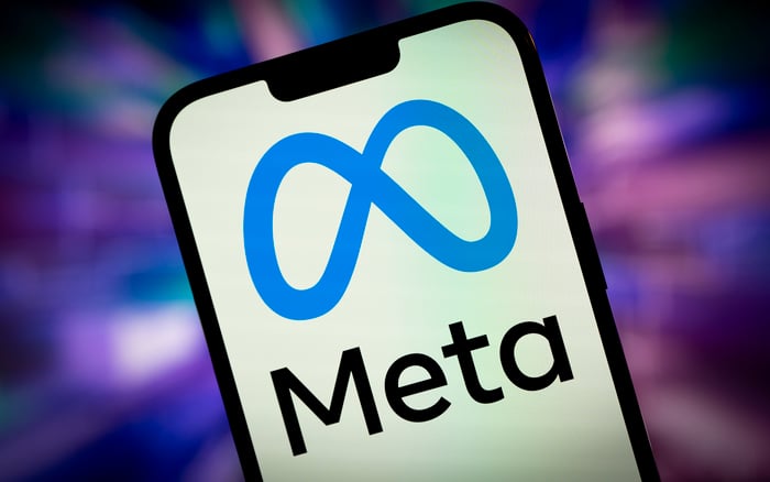 The Meta name and logo shown on a smartphone against a colorful, blurred background.