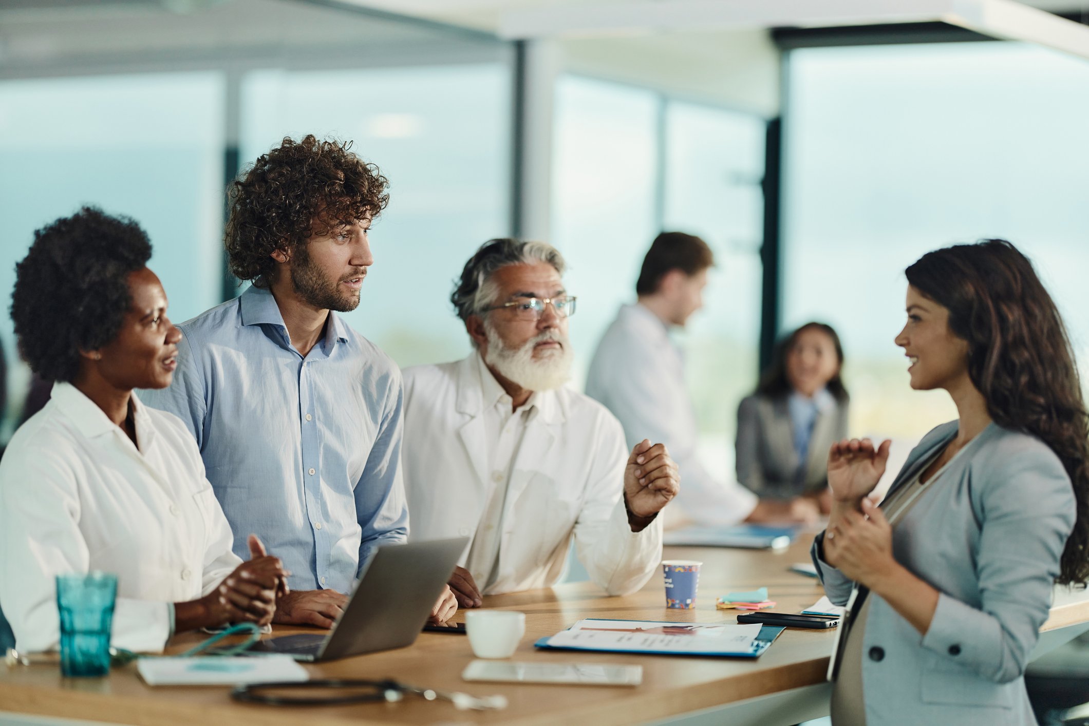 Business people and doctors talking on a meeting in hospital