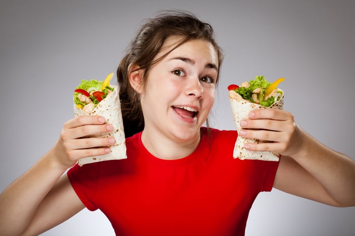 A young lady with her burrito.