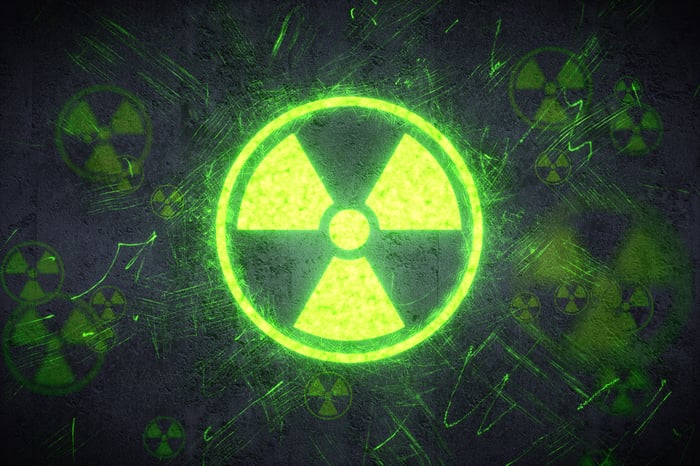 Glowing green radioactive nuclear radiation icon.