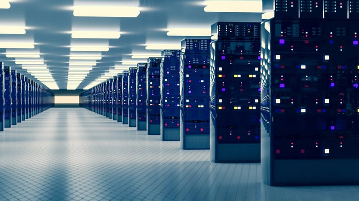 Many rows of server racks in a modern data center.