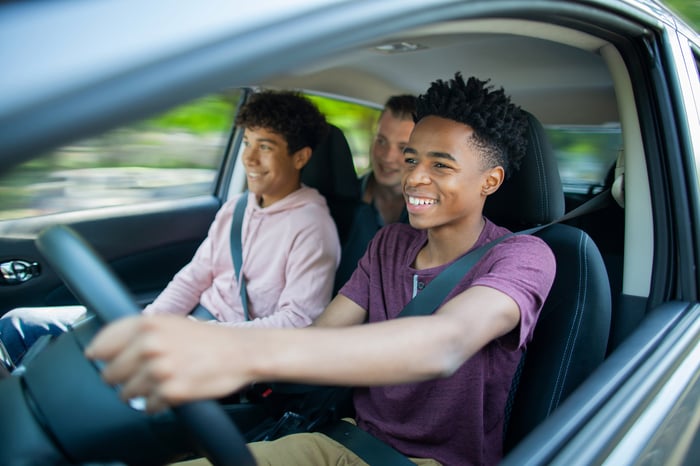 Young people in a car, enjoying a drive with the windows down.