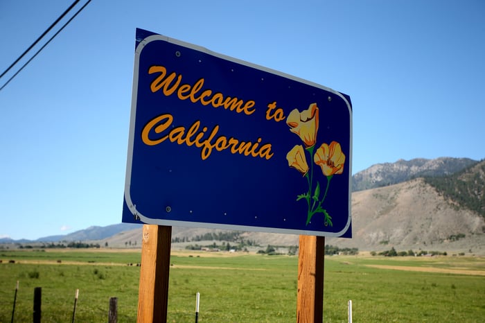 A "Welcome to California" sign by the highway.