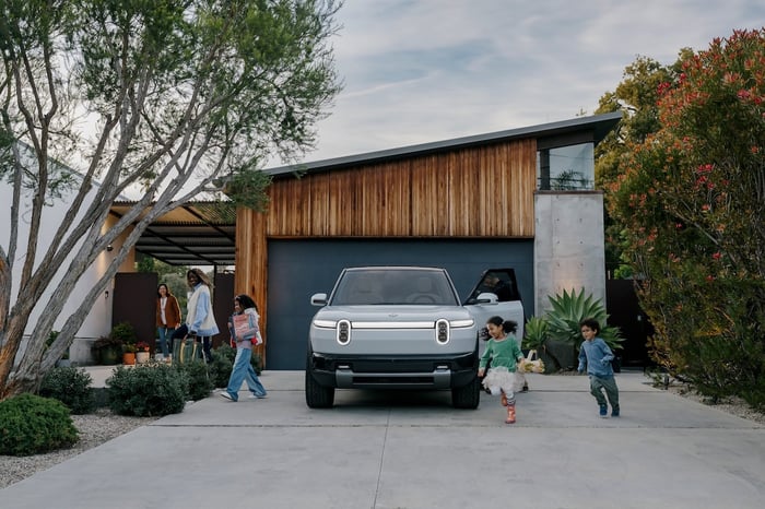 A family gets out of their Rivian R2 vehicle.