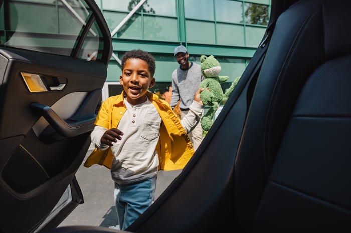 Waymo passengers get on board their robotaxi ride.