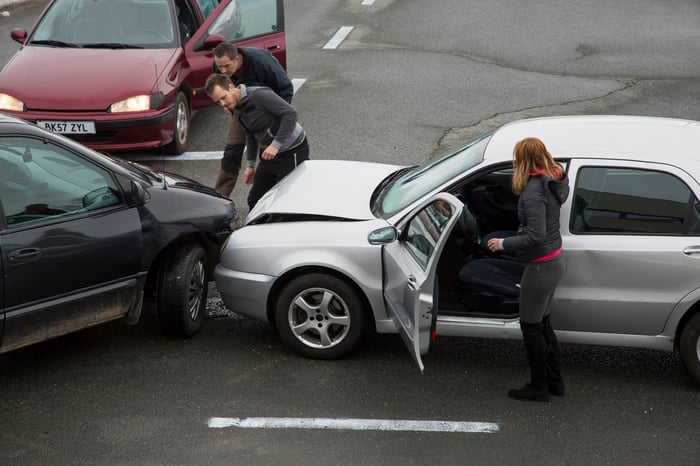 3 cars crashed in an intersection.