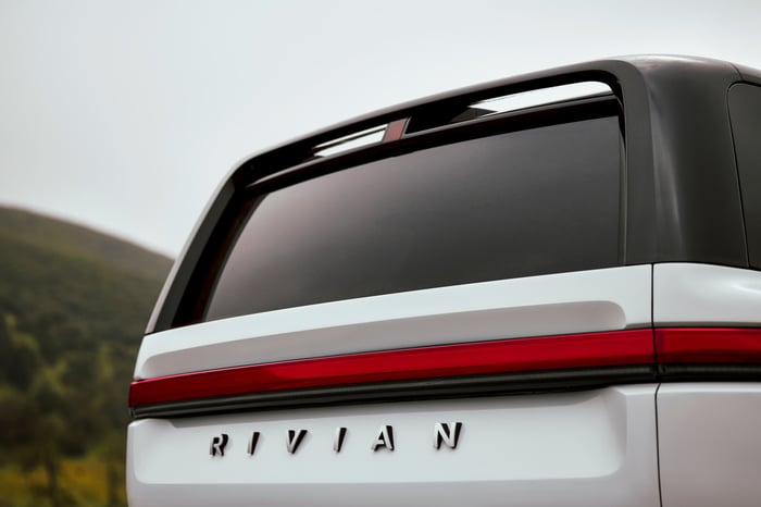 Rear view of silver Rivian R2 electric SUV. 
