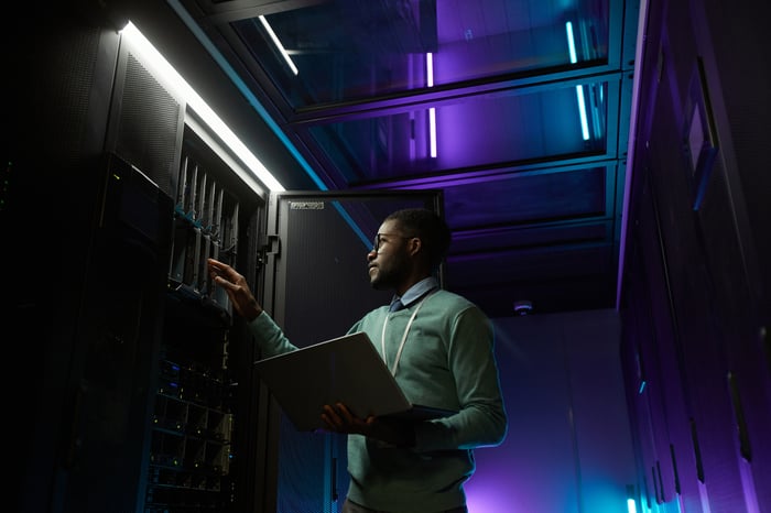 Person inspecting hardware at a data center.