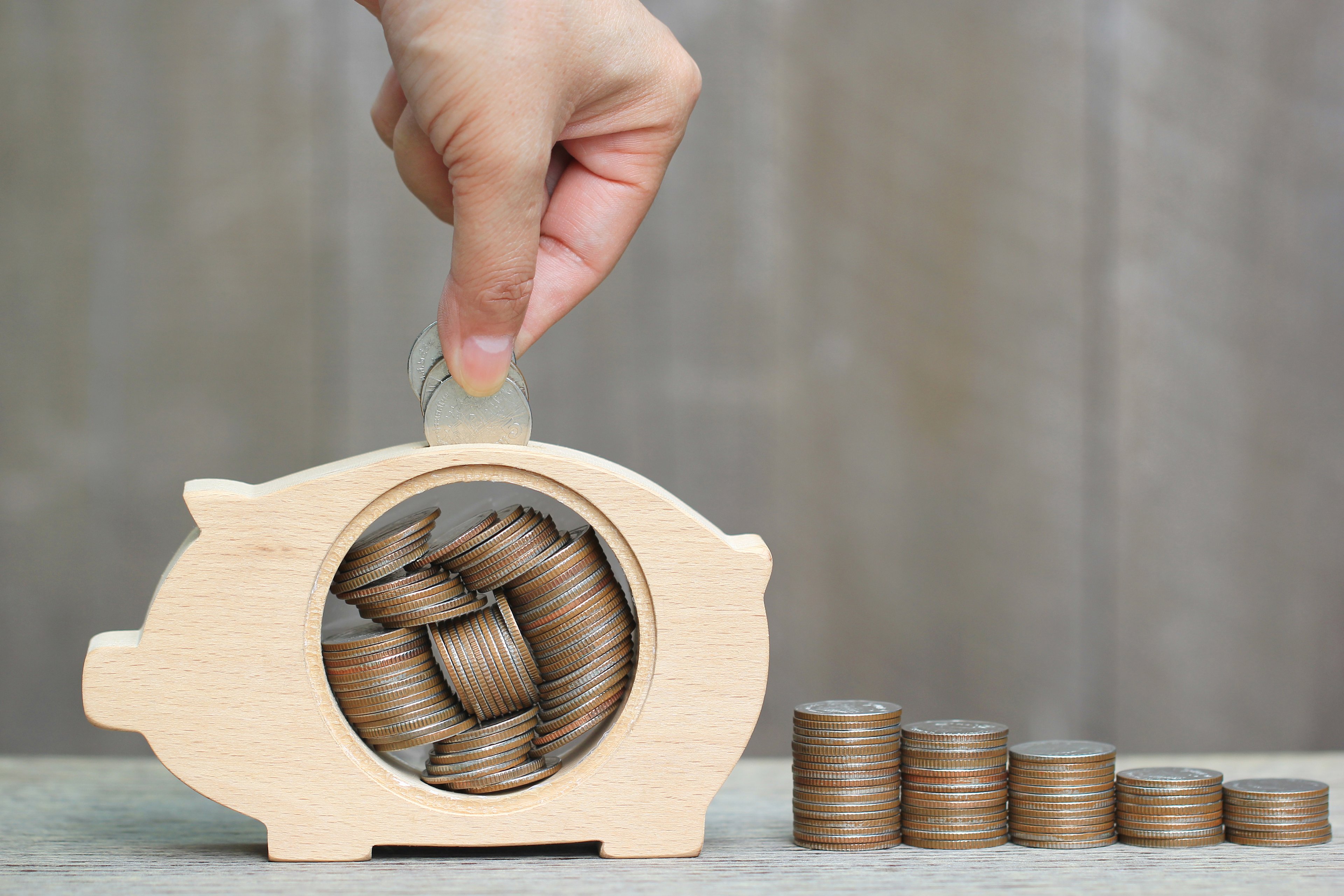 putting coins in a piggy bank