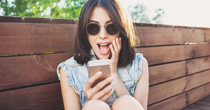 Someone excited by what they are seeing on a phone.