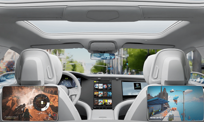Interior of a minivan, with dashboard and backseat touchscreens on.